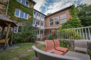a patio with chairs and a building at Flensbed Hotel & Hostel in Flensburg