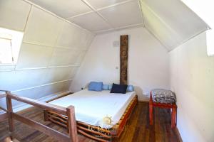 a small room with a bed and a chair at Le Port Hotel in Fort Dauphin