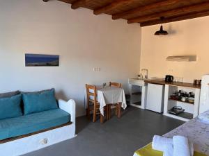 a living room with a couch and a table at KOLOMBA GUESTS House in Vrachonisída Skylonísi