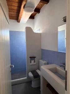 a bathroom with a white toilet and a sink at KOLOMBA GUESTS House in Vrachonisída Skylonísi