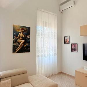 a living room with a couch and a painting on the wall at Star Apartment 2- Spacious in the heart of Durres in Durrës +15 photos