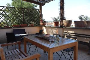 a wooden table and chairs on a patio at La terrazza di Andrea in Bolsena