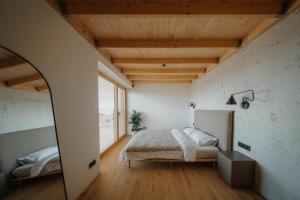 a bedroom with a bed and a large window at SVENCELE DUNES Marių g 31-1 in Svencelė