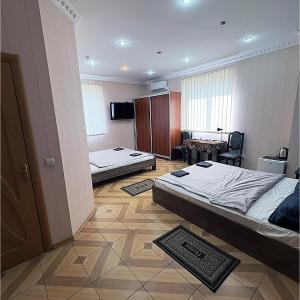 a hotel room with two beds and a desk at Mini Hotel Leon in Lalovo