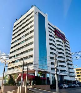 a tall white building on a city street at West Flat - BarretoStays 02 in Mossoró