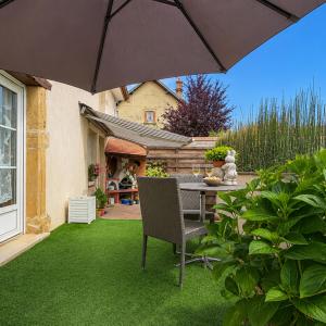 a patio with a table and an umbrella at T2 Cosy - Proche Dijon -Terrasse - Parking in Pichanges