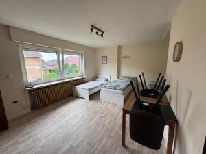 a room with a bed and a desk and a window at Monteur 3P in Fürstenau