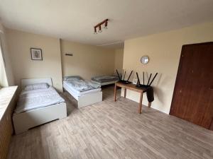 a room with two beds and a table in it at Monteur 3P in Fürstenau
