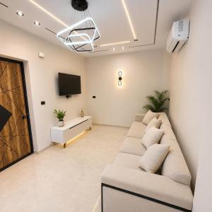 a living room with a couch and a tv at Sunrise View K8 Apartments in Hurghada