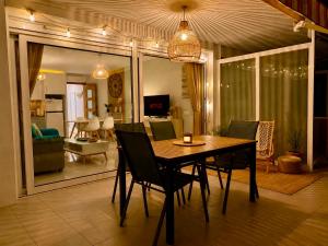 a dining room table and chairs in a living room at Almadrava Beach in Roses