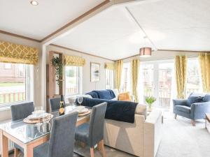 a living room with a couch and a table at Marlow Lodge in Hyssington