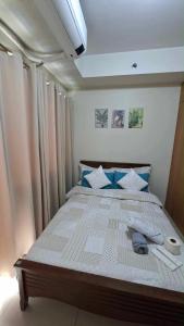a large bed in a room with curtains at Accommodating Place in Manila +13 photos