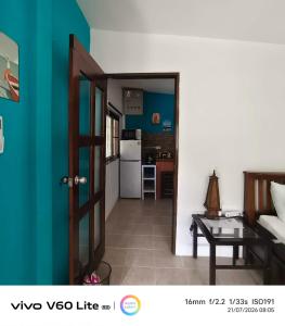 a living room with a door open to a kitchen at Escape-Cabins in Ko Lanta +161 photos