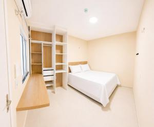 a bedroom with a bed and a book shelf at Pousada Milagres in Canindé