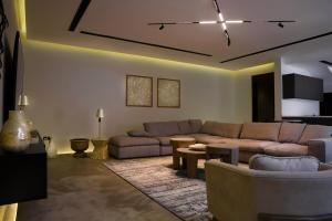 a living room with a couch and a table at Eight House villa in Jeddah