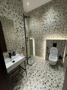 a bathroom with a toilet and a sink and a shower at Eight House villa in Jeddah +18 photos