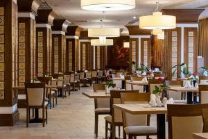 a dining room filled with tables and chairs at Mirotel Resort and Spa in Truskavets