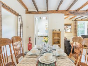 a dining room with a table and chairs at Primrose Cottage - Ukc6679 in Bettws-yn-Rhôs +25 photos