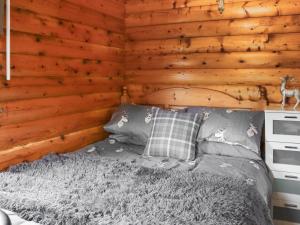 a bedroom with a bed in a wooden wall at Barken in Trawsfynydd