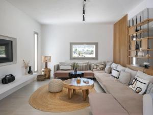 a living room with a couch and a table at Villa Bema - Quietness and Beach access in Molos Parou