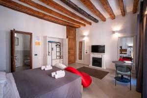 a bedroom with a bed with a red pillow on it at C&O Savoia Deluxe Rooms in Cagliari