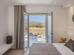 a bedroom with a bed and a balcony with a view at Villa Bema - Quietness and Beach access in Molos Parou +52 photos