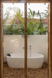 a bath tub in a bathroom with plants at Panta Rei resort in Ahangama +56 photos