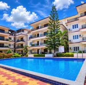 a swimming pool in front of a building at Harmony Vista in Calangute