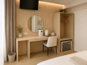 a bedroom with a desk with a mirror and a chair at Chanaplace Lanna in Chiang Mai