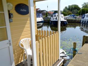 a porch of a house with boats in the water at Ardea - Uk12695 in Stalham +2 photos