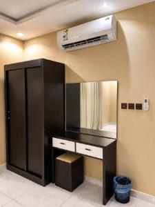 a room with a desk with a air conditioner on the ceiling at Mdmak Suites in Riyadh +2 photos