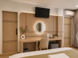 a hotel room with a desk and a mirror at Chanaplace Lanna in Chiang Mai +20 photos