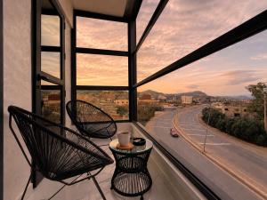 a balcony with two chairs and a view of a highway at Royal Rif Alhoceima in Al Hoceïma +95 photos