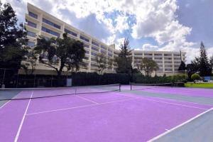 a tennis court in front of a building at Grand Cantalagua Hotel Morelia, BW Signature Collection in Morelia