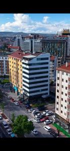 a city with cars parked in a parking lot at Panorama Rezidans Kayseri in Kayseri