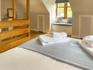 two towels on a bed in a room at Innish Beag - Uk38782 in Clachan +14 photos
