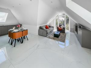 a white living room with a table and a couch at Apartment 5 - Uk51650 in Maldon