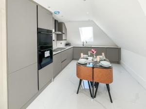 a kitchen with a small table and a stove at Apartment 5 - Uk51650 in Maldon