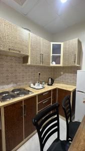 a kitchen with a counter and a stove top oven at النسمة الهادئة - إقتصادى in Jeddah