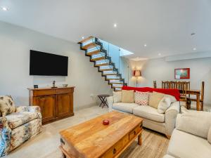 a living room with a couch and a tv at Ash Hill - Uk36199 in Fordingbridge
