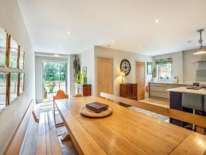 a kitchen and living room with a wooden table at Homewood - Uk36205 in Fordingbridge