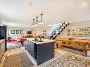 an open kitchen and living room with a staircase at Homewood - Uk36205 in Fordingbridge +15 photos