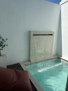 a swimming pool in the corner of a room at Love Box Resort in Samutprakarn