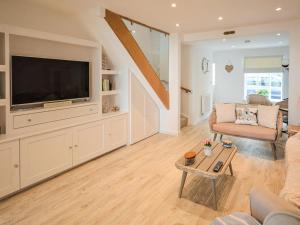 a living room with a large flat screen tv at Jan Dee Cottage in Ventnor