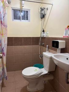 a bathroom with a toilet and a sink at Arezzo Place in Davao City