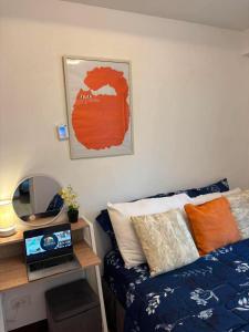 a room with a couch and a table with a laptop at Arezzo Place in Davao City
