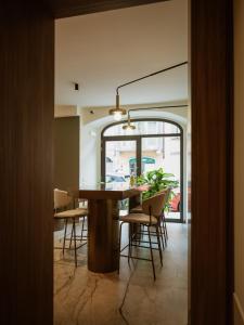 a dining room with a table and chairs at Ca Moroni Collection in Bergamo