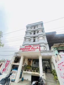a large white building with a sign on it at Hotel Dharma Heights - Sector 11 Noida in Noida