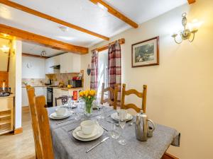 a kitchen and dining room with a table and chairs at Lavender Cottage - Ukc6677 in Bettws-yn-Rhôs +18 photos