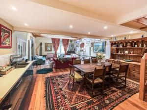 a kitchen and living room with a table and chairs at Munns Farm Barn in Earls Colne